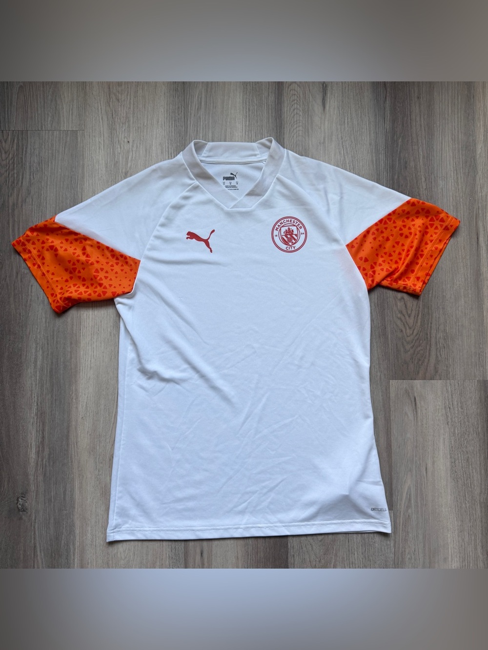 Puma Manchester City 2023/24 Training Jersey in white and orange, size medium